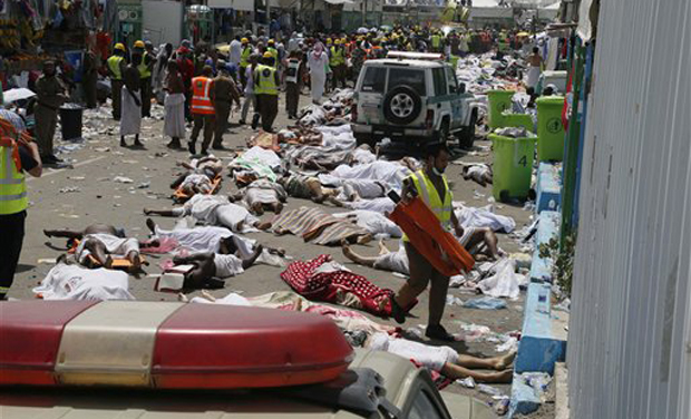 Muslim pilgrims and rescuers gather around the victims of a stampede in Mina. (Photo: PTI) Muslim pilgrims and rescuers gather around the victims of a stampede in Mina. (Photo: PTI)